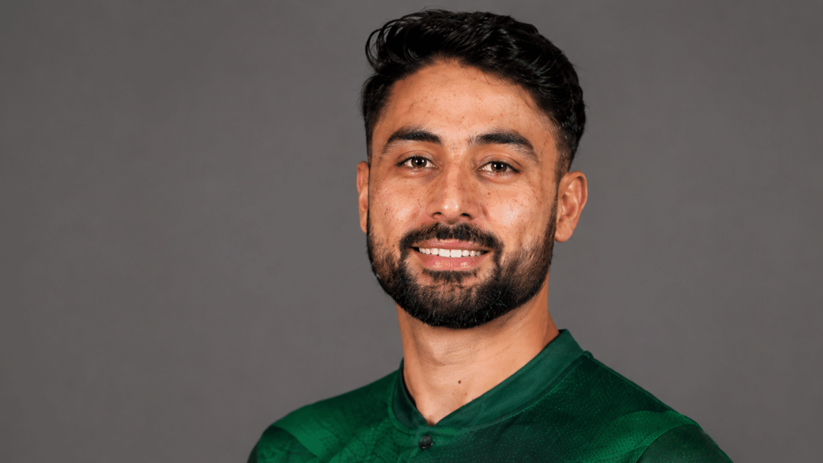 Pakistan spinner Abrar Ahmed poses for an official team portrait wearing a green cricket jersey.