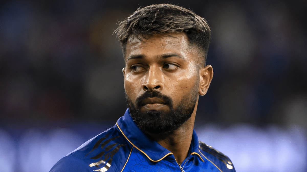 Ultra-realistic close-up portrait of a cricketer looking to the side on the field, featuring sharp facial detail and a blurred stadium backdrop.