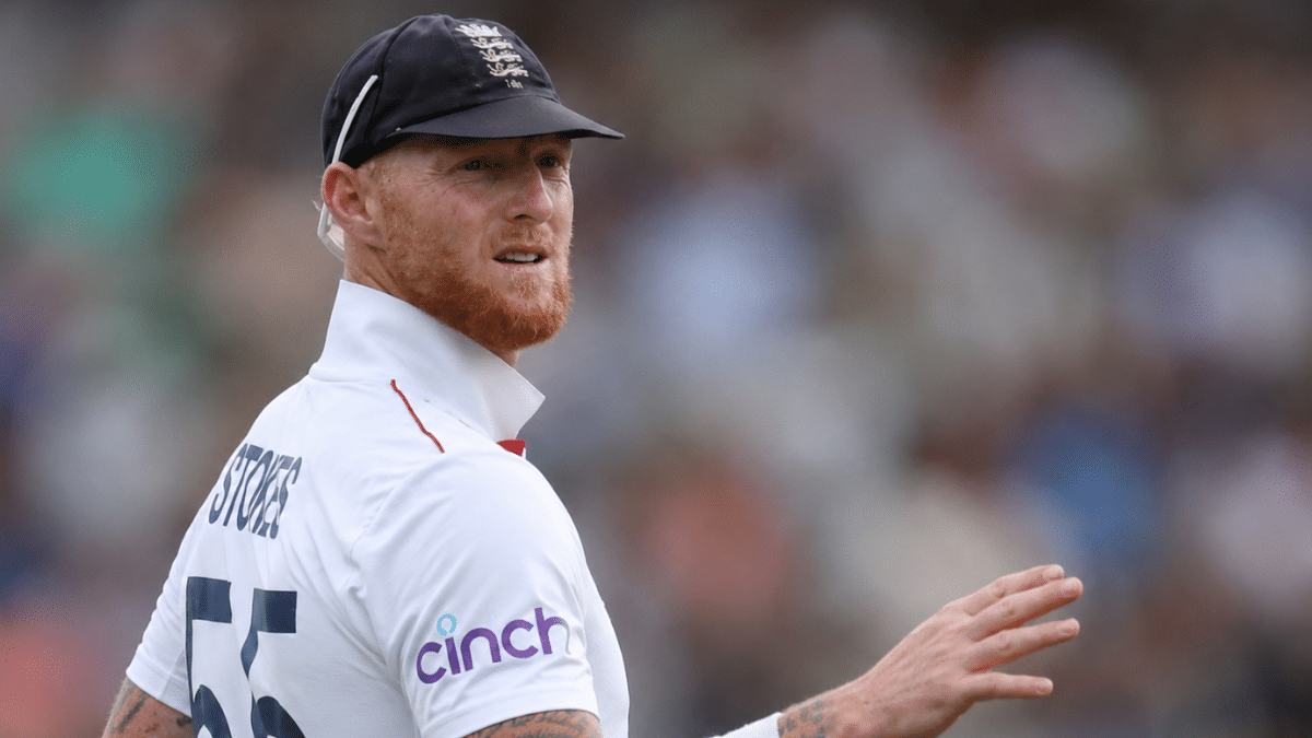 Ultra-realistic rear side-angle photograph of Ben Stokes during a Test match, captured with a shallow depth of field and blurred crowd.