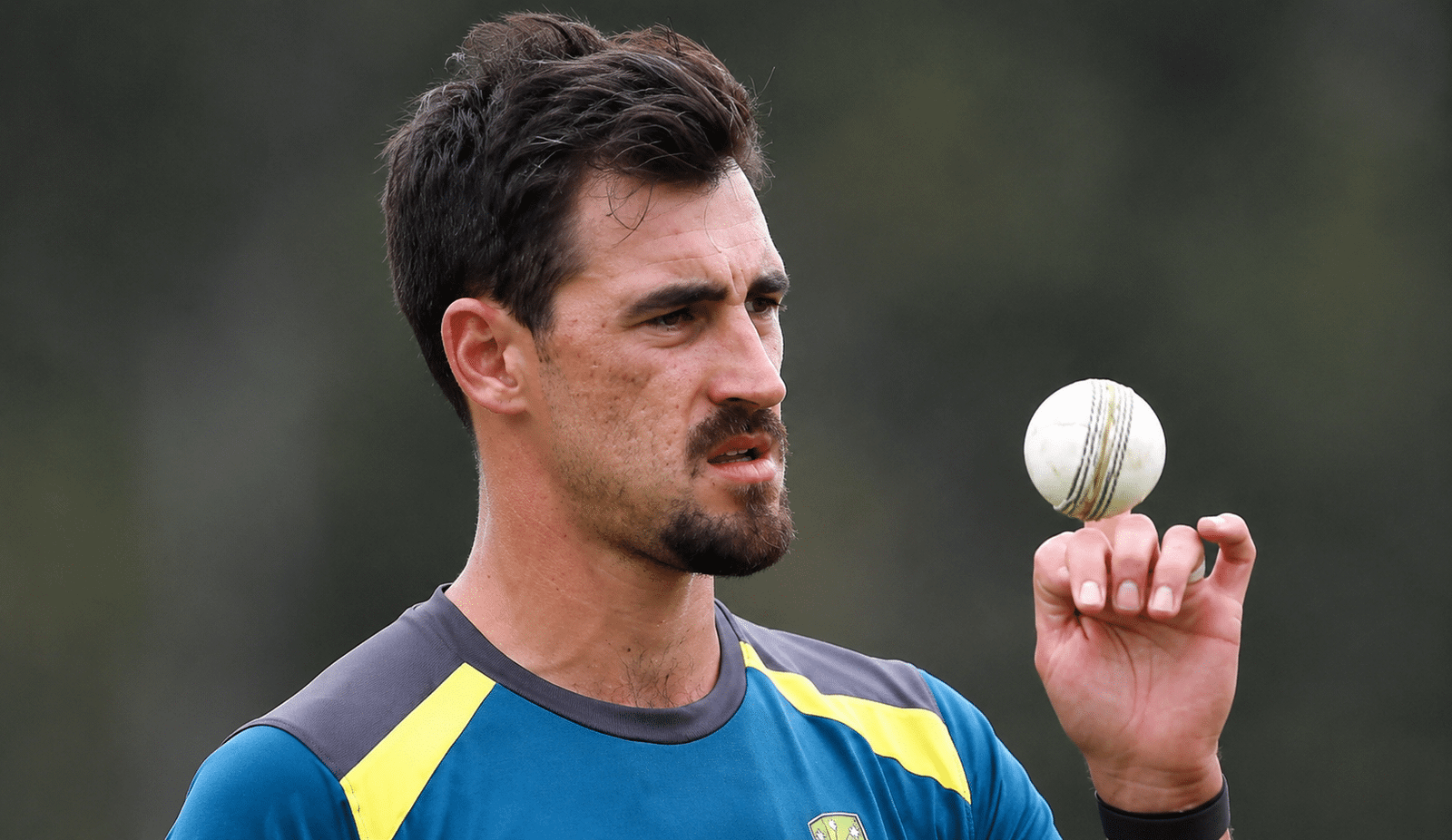 Mitchell Starc holding a cricket ball during training