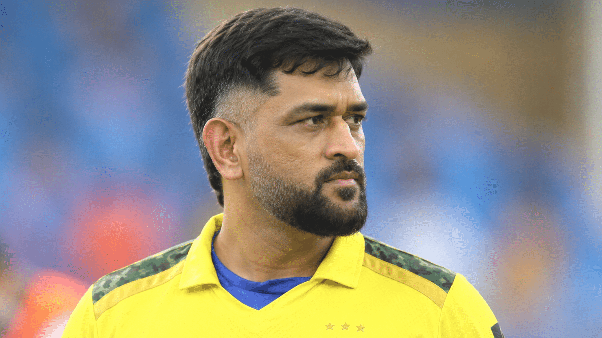 “Indian cricket player in a yellow CSK-style jersey, looking toward the right side during a stadium match, close-up portrait.”