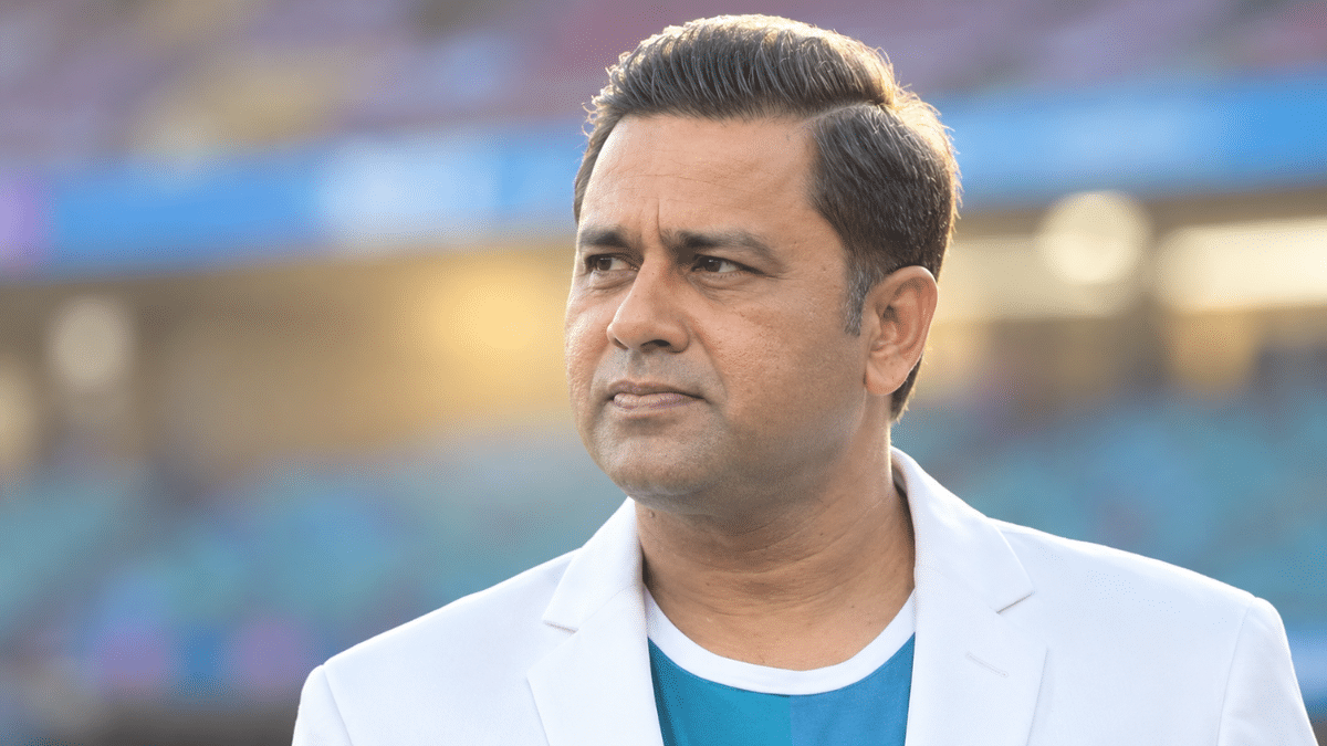 Aakash Chopra, former Indian opening batter and cricket commentator, wearing a white blazer over a teal shirt.