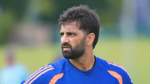 Auqib Nabi, Indian cricketer, wearing a blue training jersey.