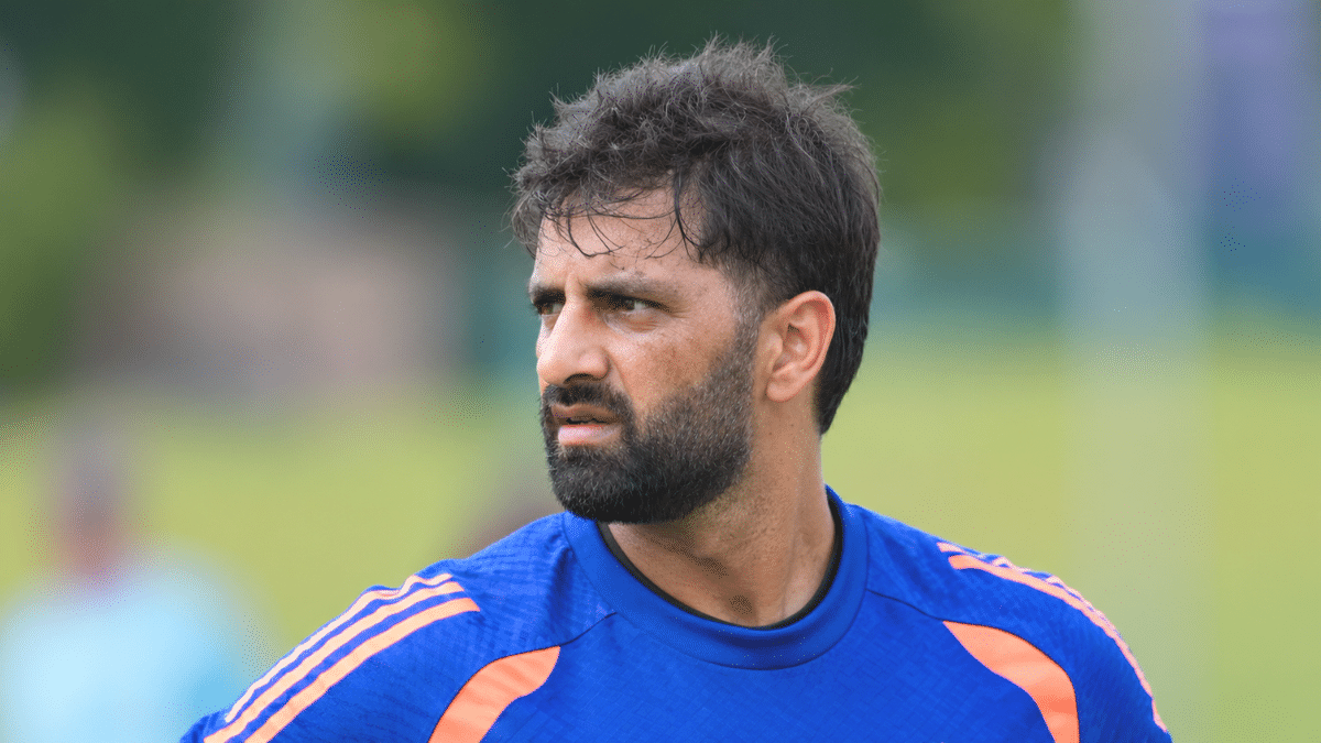 Auqib Nabi, Indian cricketer, wearing a blue training jersey.