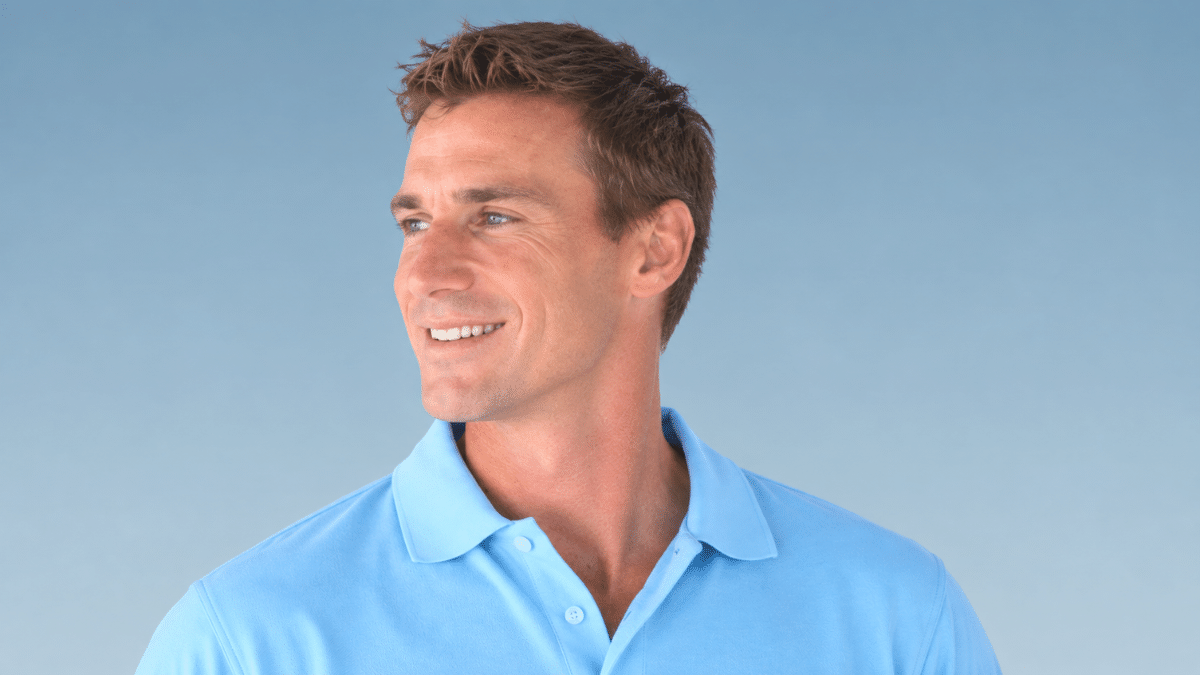 Dale Steyn smiling in a light blue shirt, facing slightly left against a blue background.