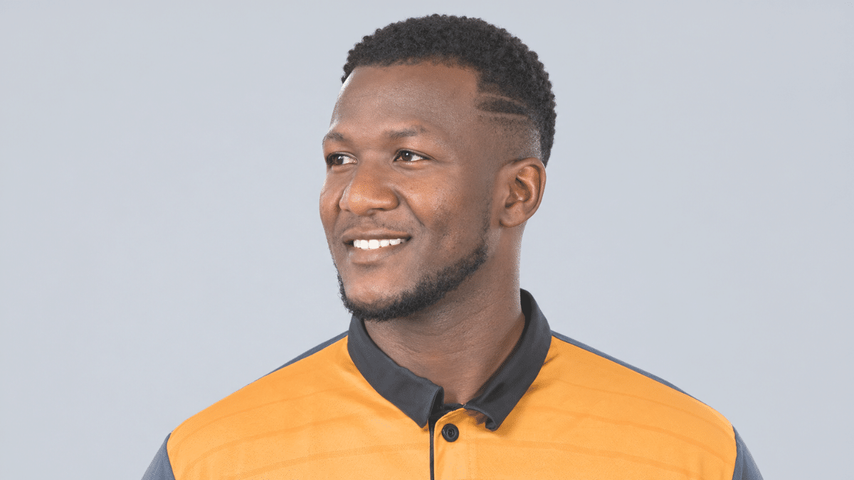 Daren Sammy, former West Indies cricketer and head coach, wearing an orange cricket jersey.
