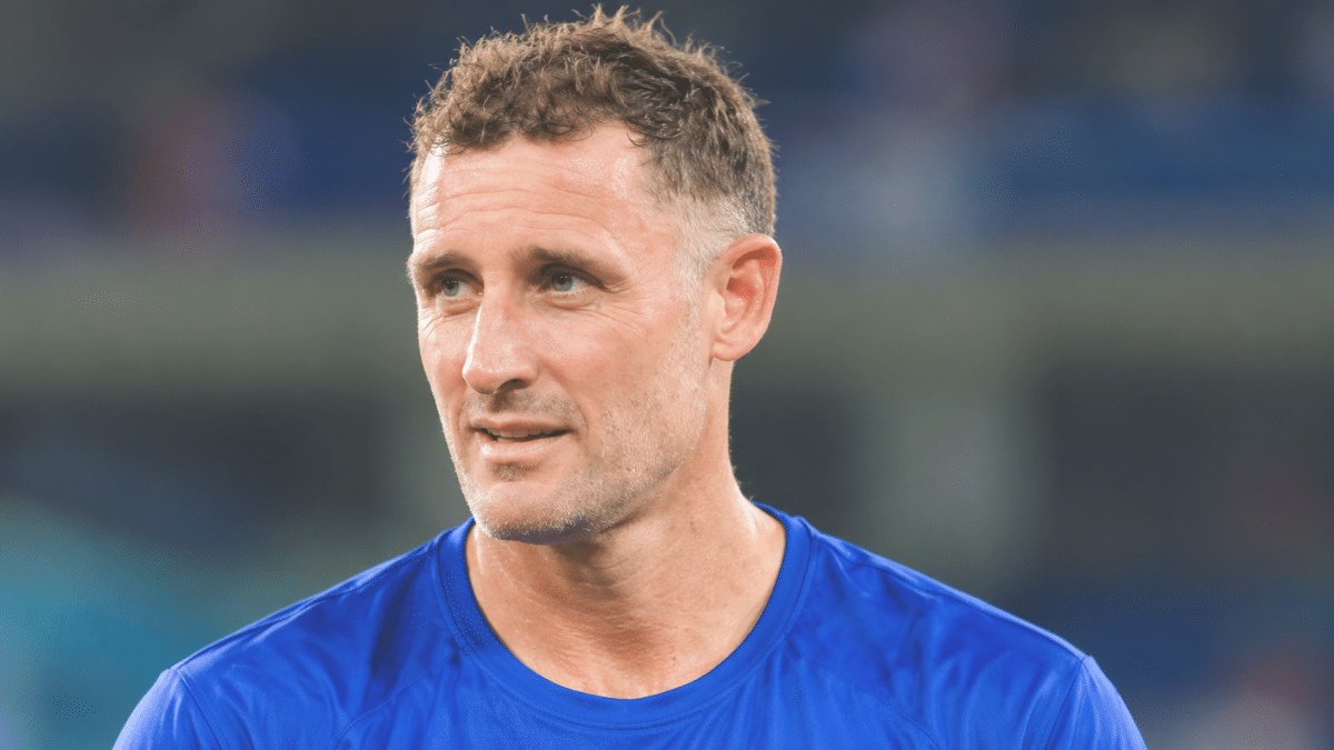 Michael Hussey, former Australian cricketer and left-handed batter, wearing a blue sports jersey
