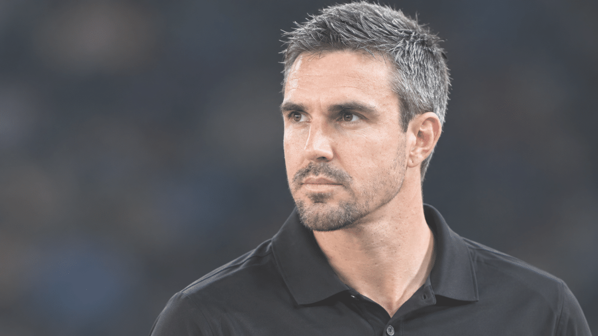 Kevin Pietersen right-side angle portrait in a black collared shirt.