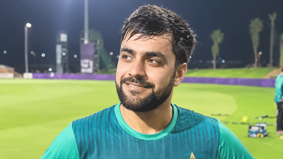 Rashid Khan, Afghanistan cricketer and right-arm leg-spin bowler, wearing a cricket jersey.