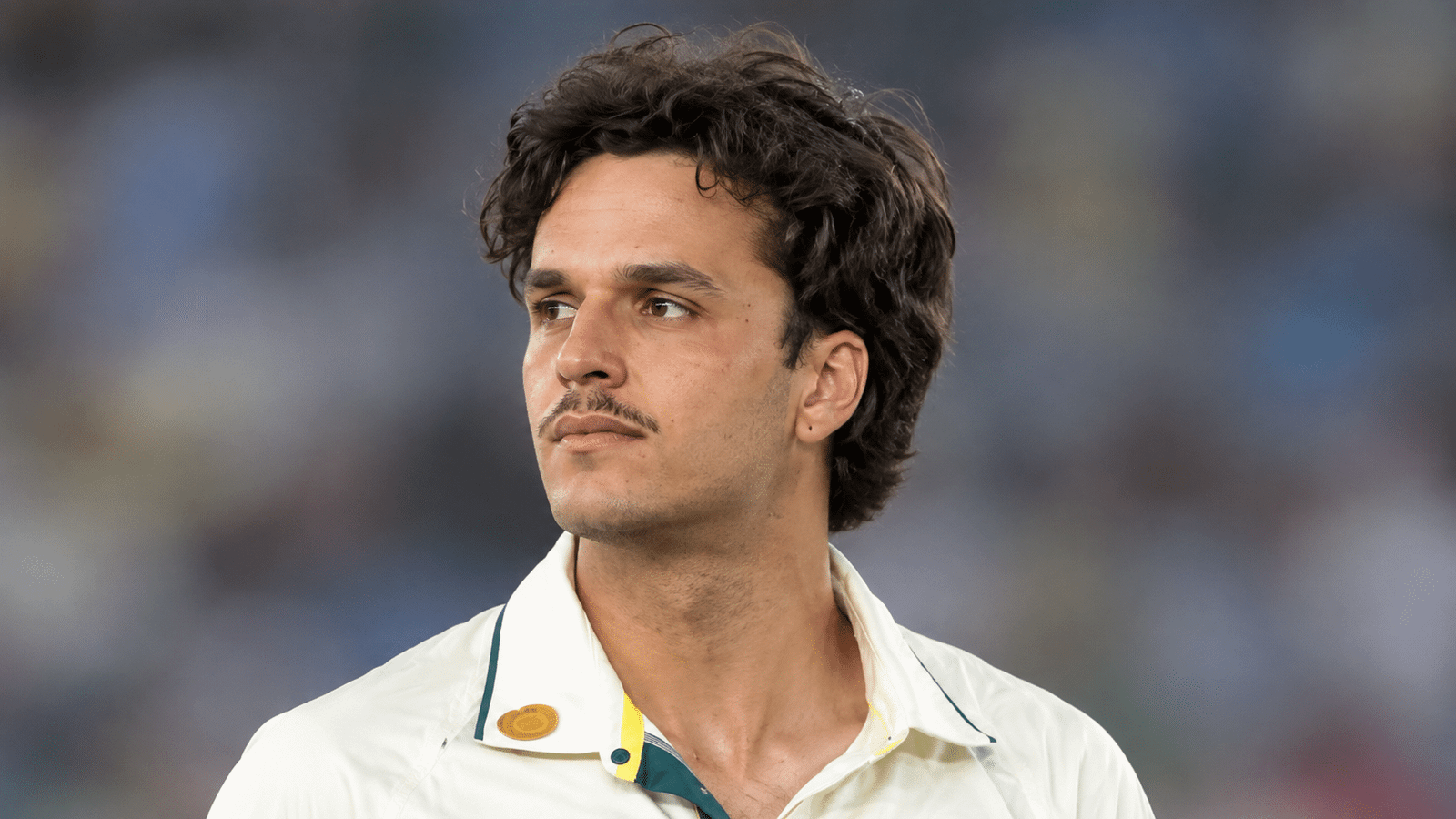 Sam Konstas, Australian right-handed batter, wearing a white cricket shirt and looking to the side.