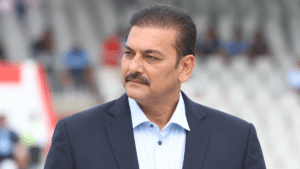 Ravi Shastri, former Indian all-rounder and India head coach, wearing a navy blazer over a light blue shirt and looking to the side.