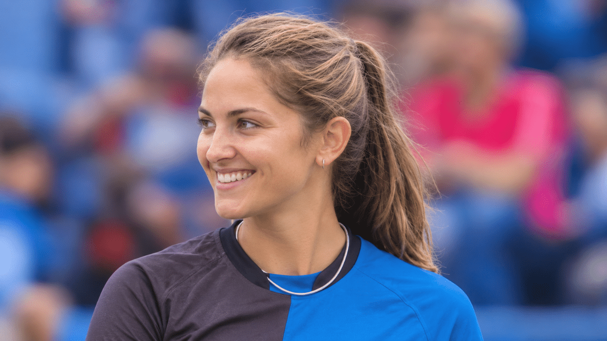 Sophie Molineux smiling and looking to the side at a cricket stadium.