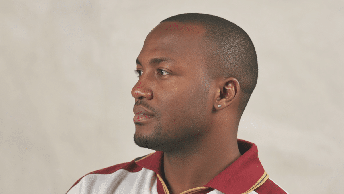 Brian Lara, former West Indies left-handed batter, wearing a maroon-and-white cricket jersey and looking to the left.