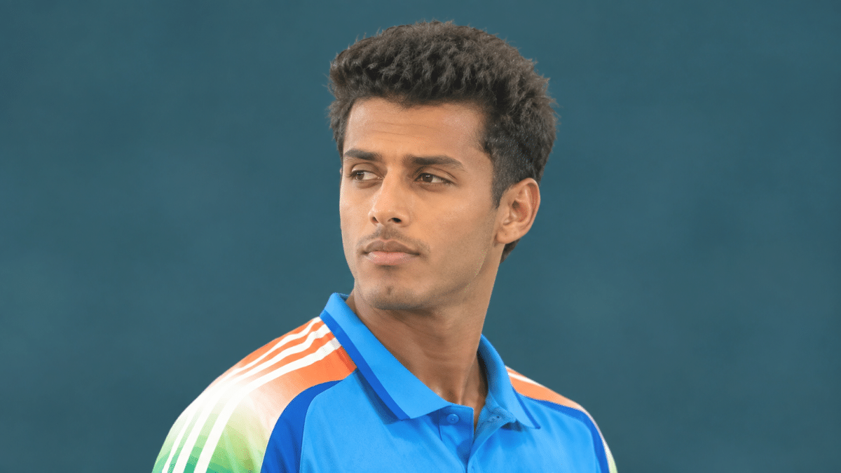 Suryansh Shedge, Indian batting all-rounder, wearing a blue cricket jersey and looking to the left.