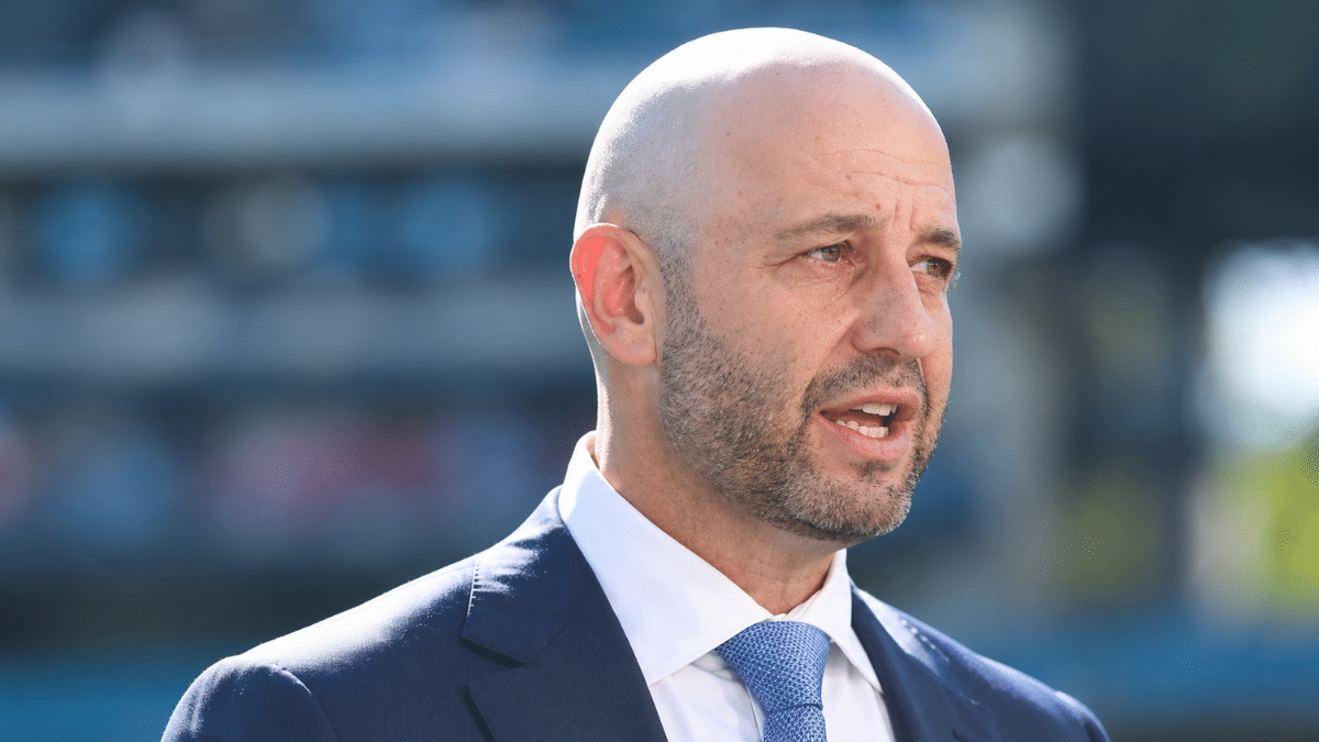 Todd Greenberg, Cricket Australia CEO, wearing a navy suit, white shirt and blue tie, looking to the right