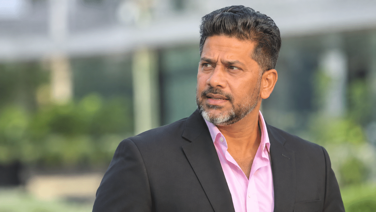 Vikrant Gupta, Indian sports journalist and cricket analyst, wearing a black blazer over a pink shirt and looking to the left.