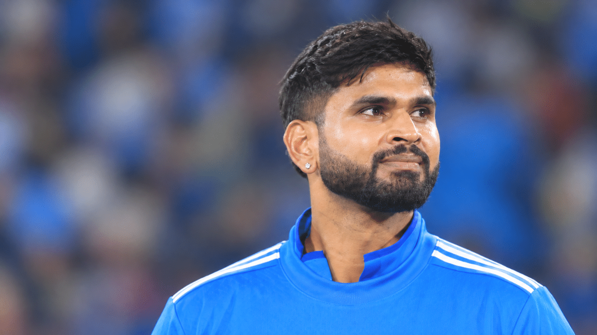 Shreyas Iyer, Indian cricketer, wearing a blue cricket jersey.